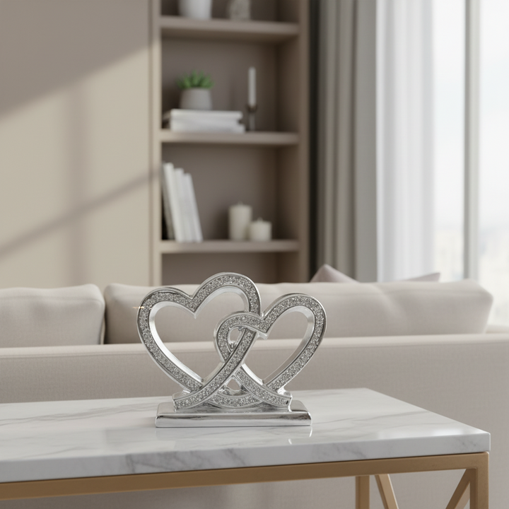 Decorative item with interlocking hearts on a marble table in a living room setting.