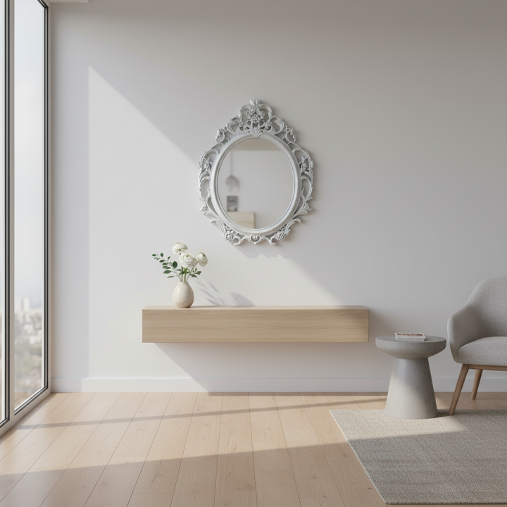 Modern interior with a decorative mirror, table, and chair in a bright room.